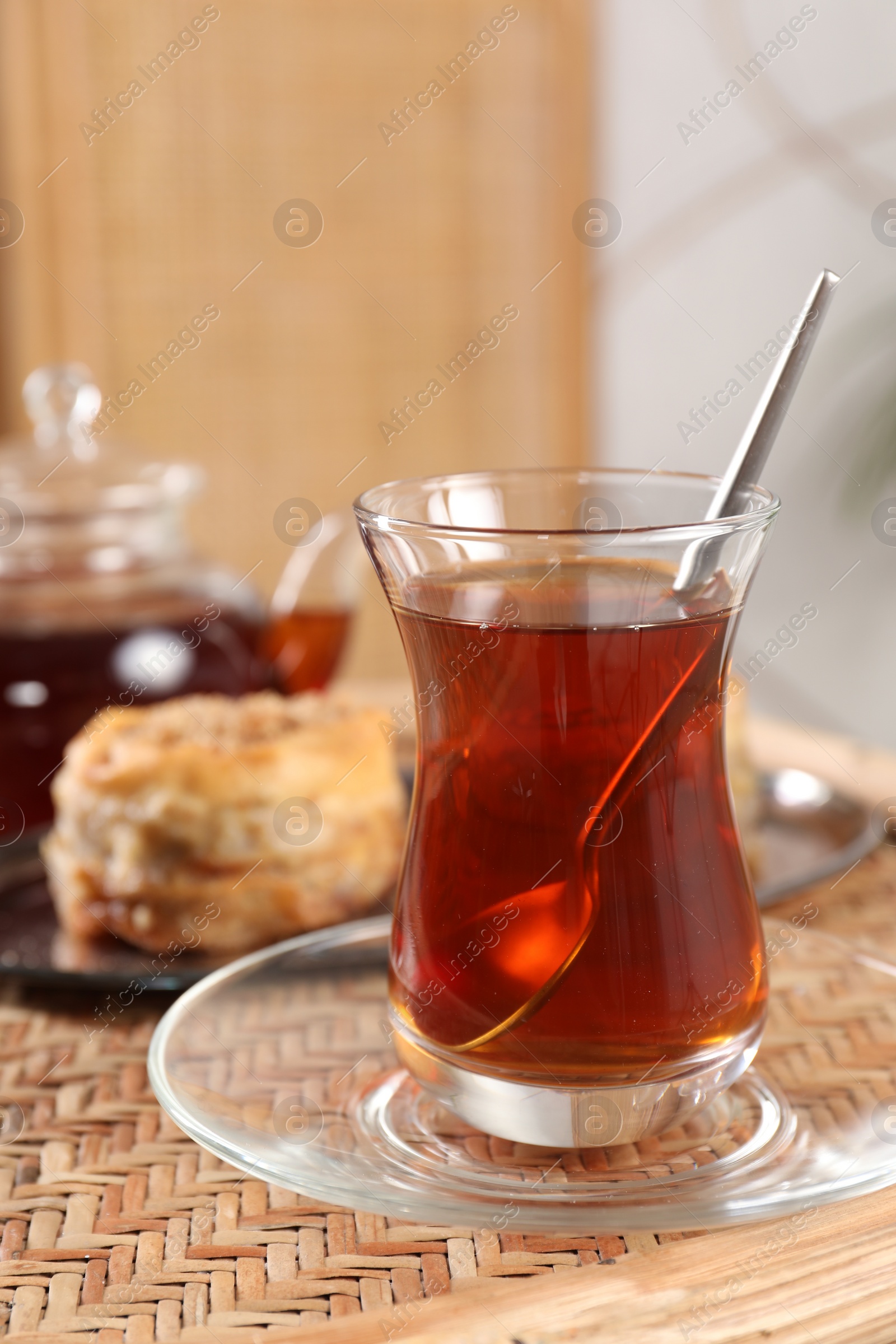 Photo of Traditional Turkish tea in glass on wicker table