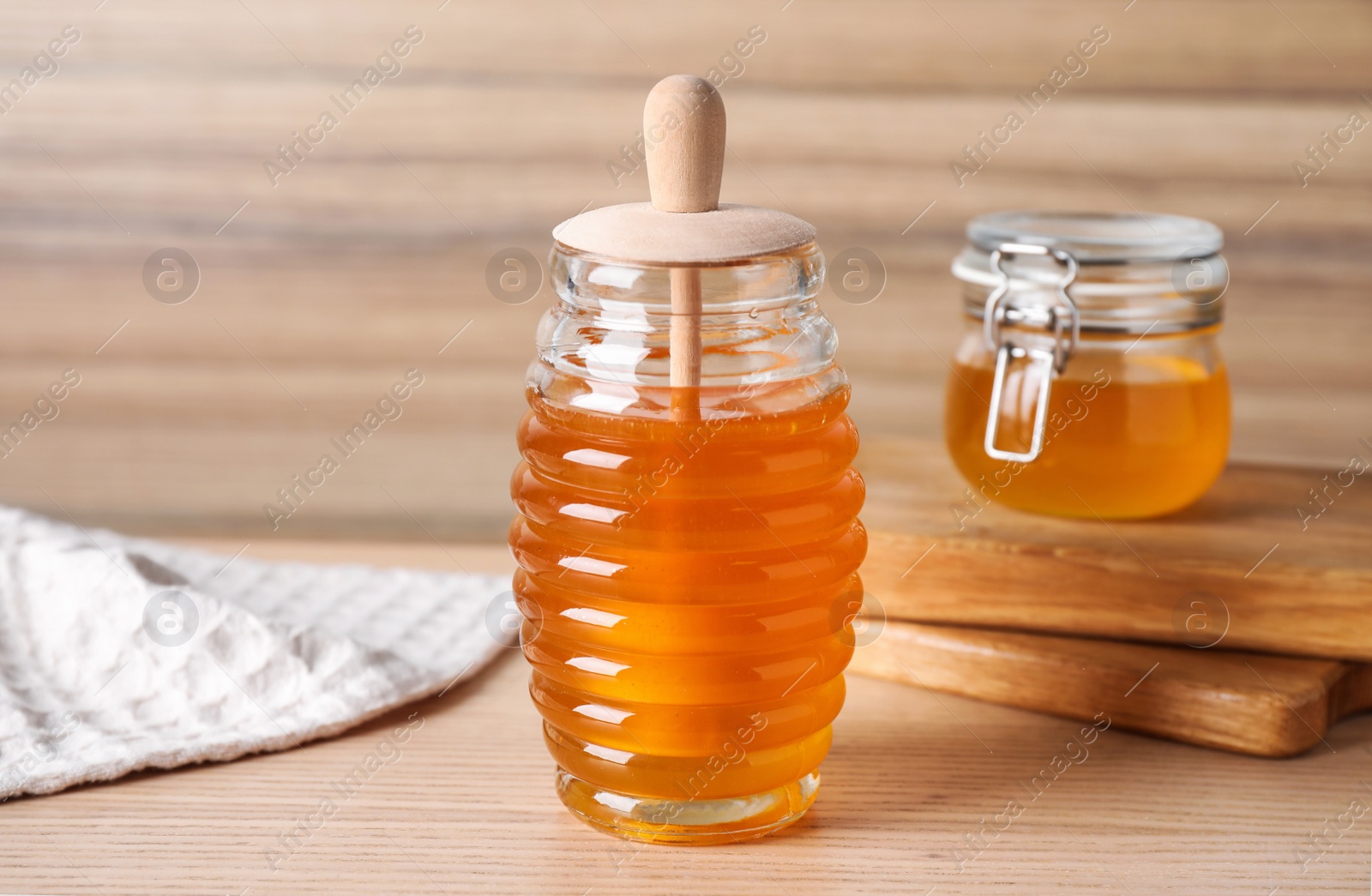 Photo of Tasty fresh organic honey on wooden table