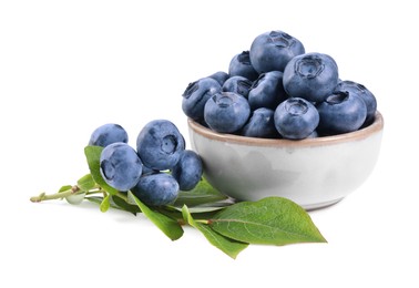 Photo of Fresh ripe blueberries and leaves isolated on white