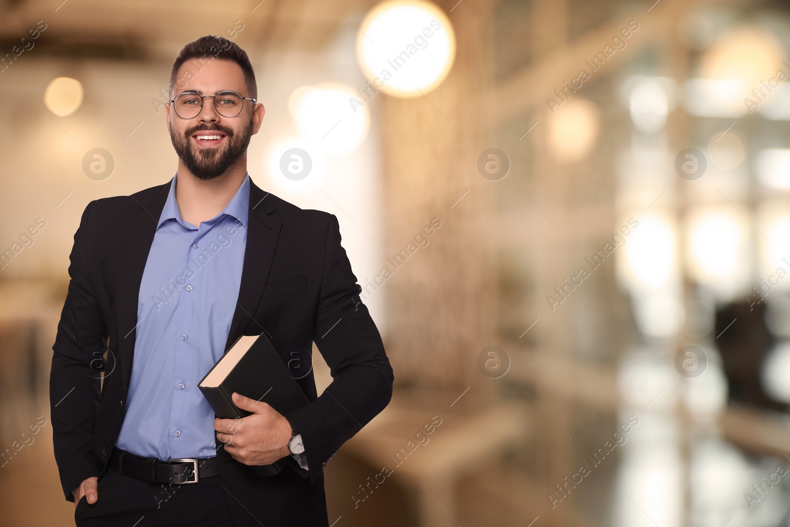 Image of Successful lawyer with book on blurred background, space for text