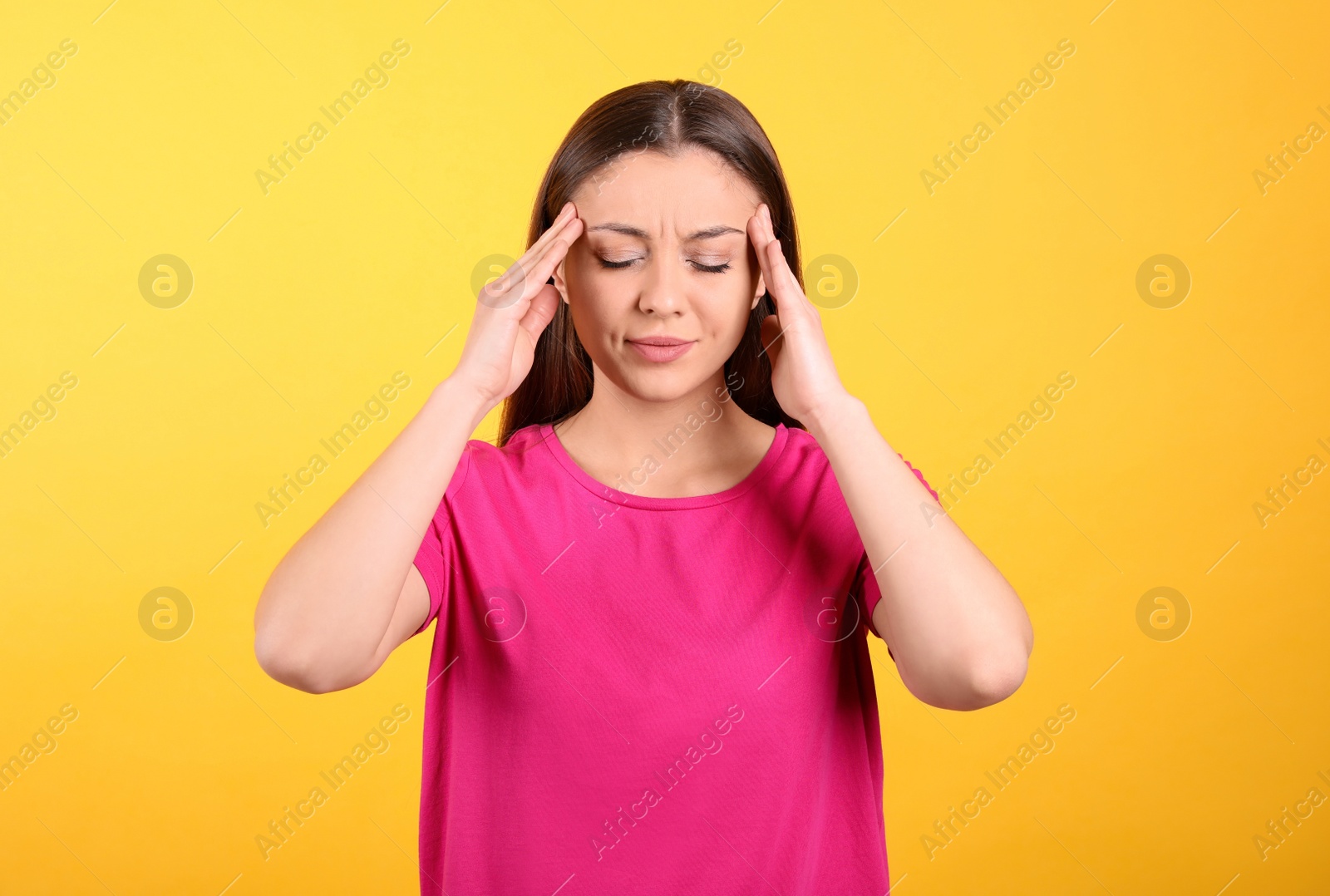 Photo of Portrait of stressed young woman on yellow background