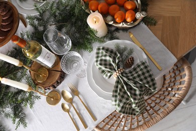 Christmas table setting with festive decor and dishware, top view