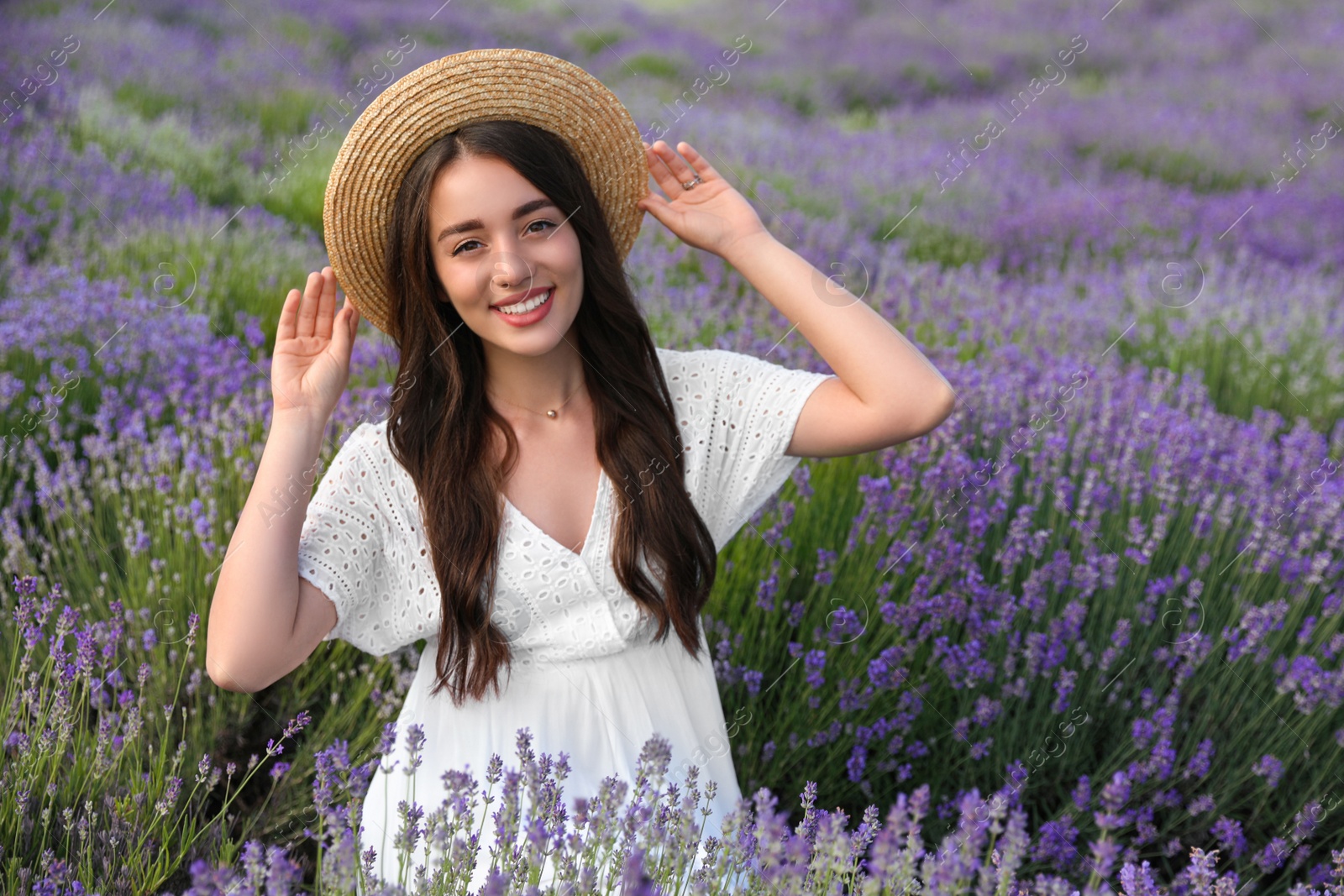 Photo of Young woman in lavender field on summer day