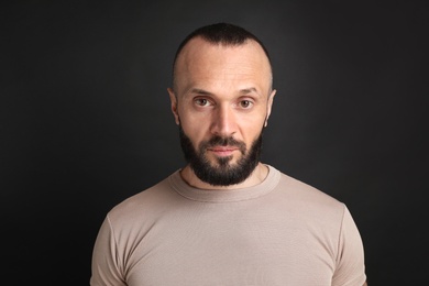 Portrait of handsome man on black background