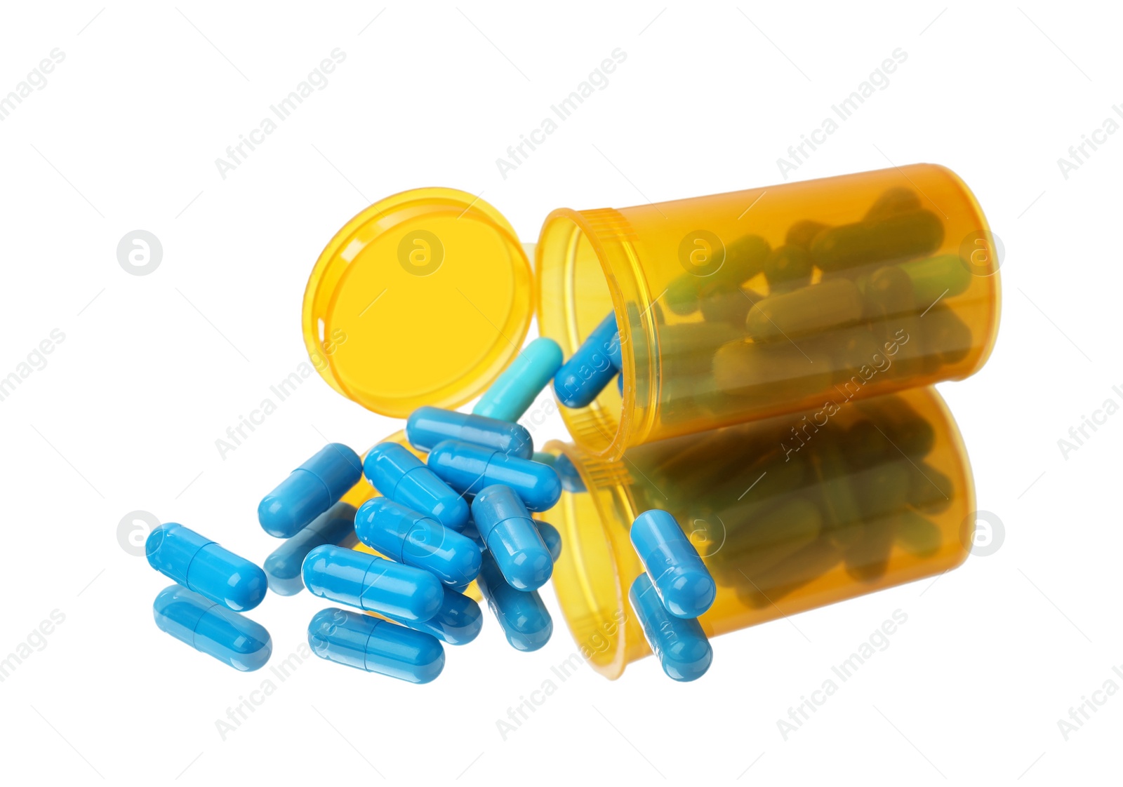 Photo of Bottle with pills on mirror surface