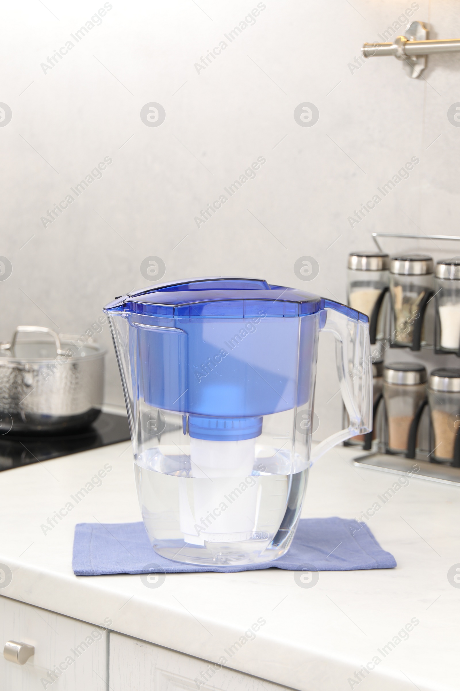 Photo of Water filter jug on white countertop in kitchen