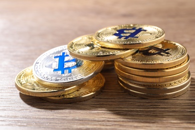 Photo of Shiny bitcoins on wooden background. Digital currency