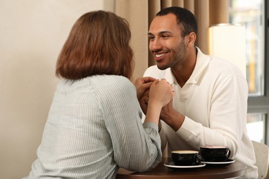 Photo of Romantic date. Happy couple spending time together in cafe