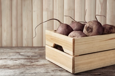 Photo of Box with whole fresh beets on wooden table