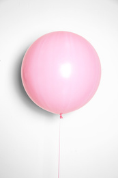 Photo of Beautiful pink helium balloon on beige background
