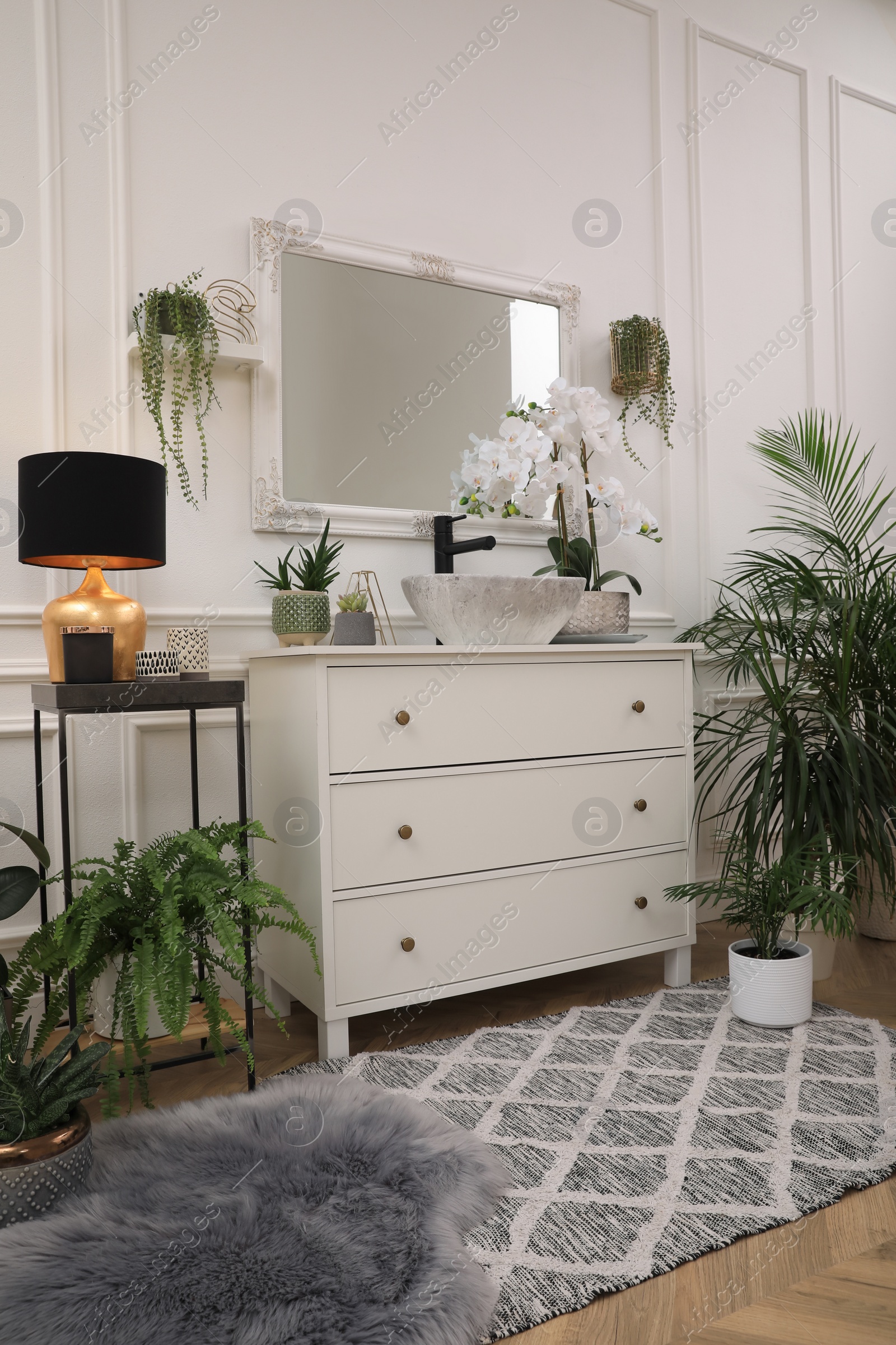 Photo of Stylish bathroom interior with modern furniture and beautiful houseplants