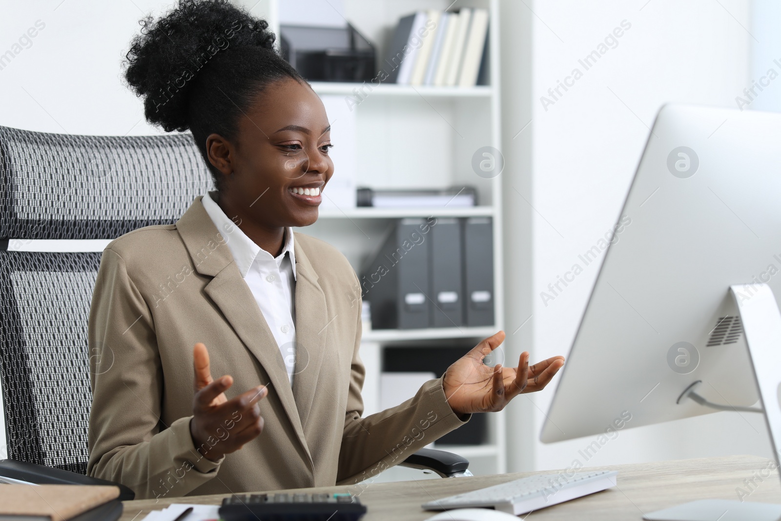 Photo of Professional accountant having video chat via computer at wooden desk in office