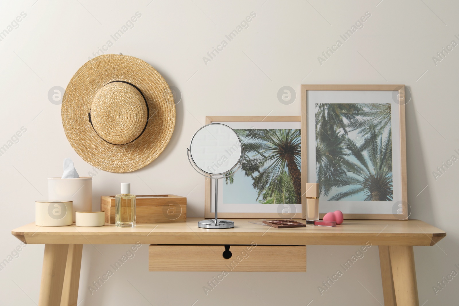 Photo of Dressing table with mirror, makeup products and accessories in room