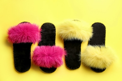 Photo of Different soft slippers on yellow background, flat lay