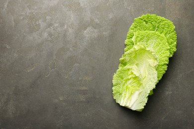 Fresh Chinese cabbage leaves on gray textured table, top view. Space for text