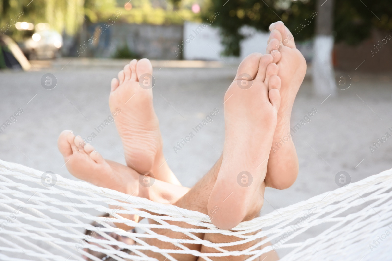 Photo of Young couple resting in hammock at seaside. Summer vacation