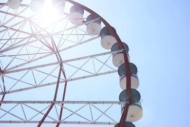 Beautiful Ferris wheel against blue sky on sunny day, low angle view