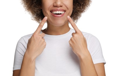 Woman showing her clean teeth and smiling on white background, closeup