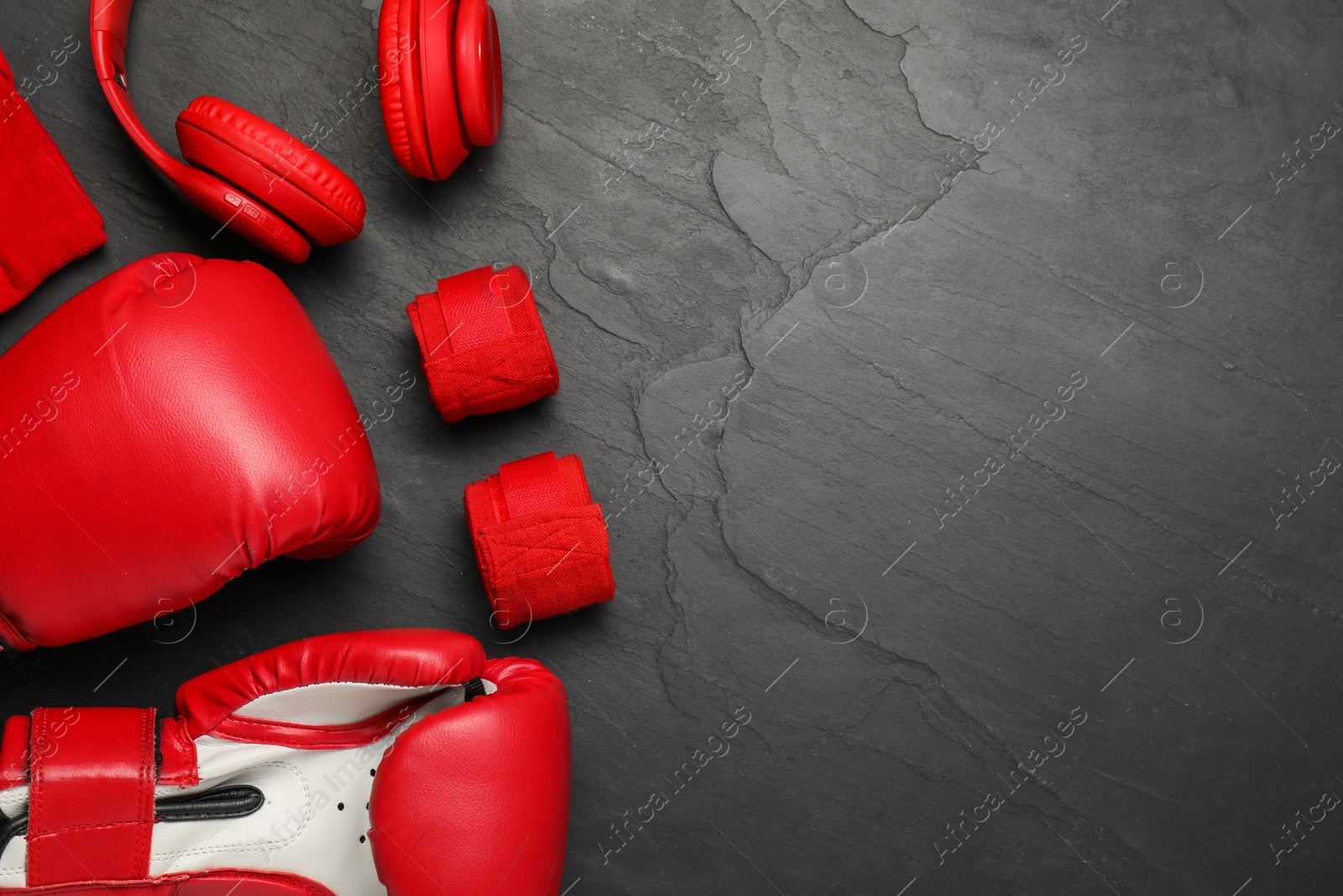 Photo of Different sports equipment on black table, flat lay. Space for text