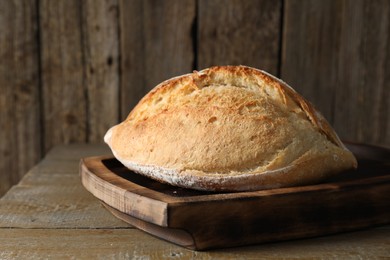 Photo of Freshly baked sourdough bread on wooden table