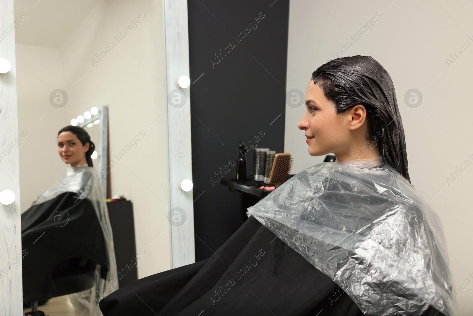 Photo of Young woman with dyed hair in beauty salon