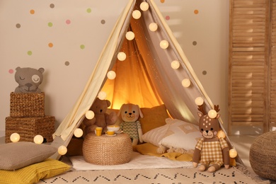 Photo of Modern children's room interior with play tent