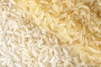 Photo of Different types of rice as background, closeup