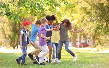 Photo of Cute little children playing with ball outdoors on sunny day