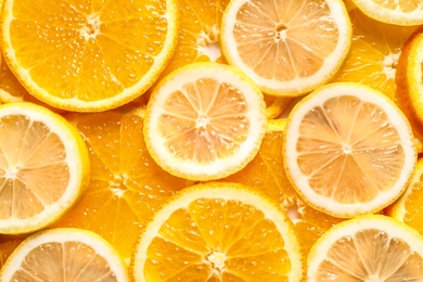 Photo of Slices of citrus fruits as background, top view