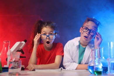 Photo of Emotional children in laboratory after explosion. Dangerous experiment