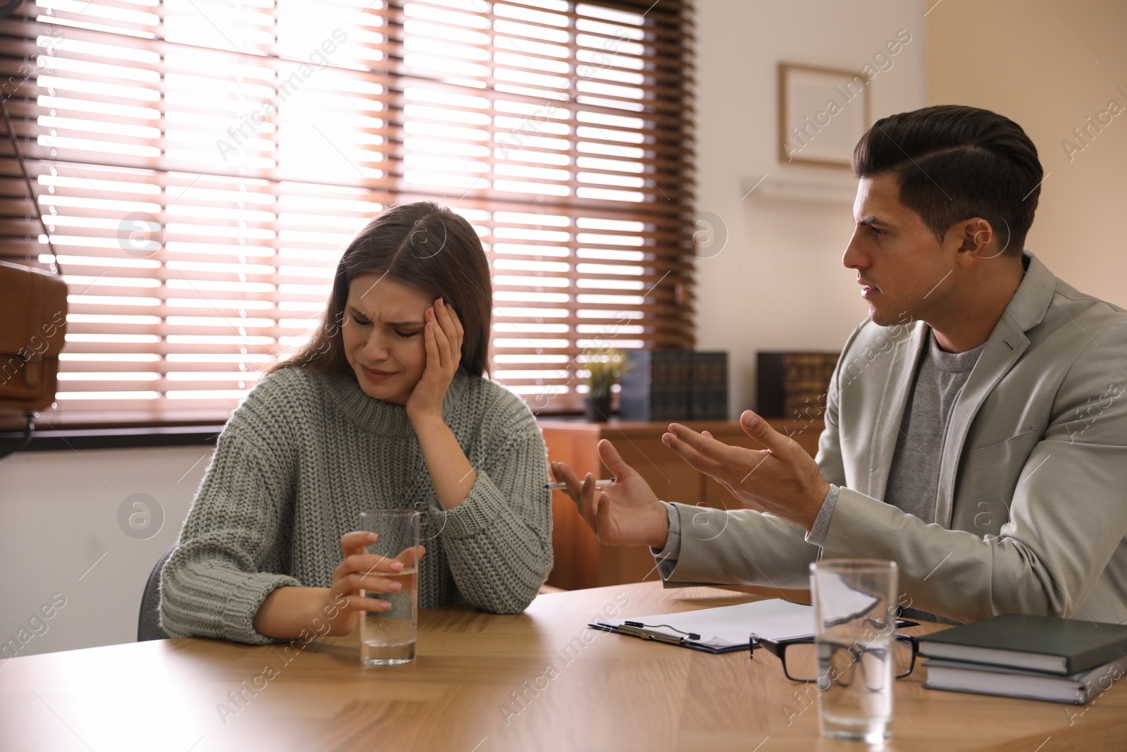 Photo of Professional psychotherapist working with patient in office