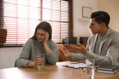 Photo of Professional psychotherapist working with patient in office