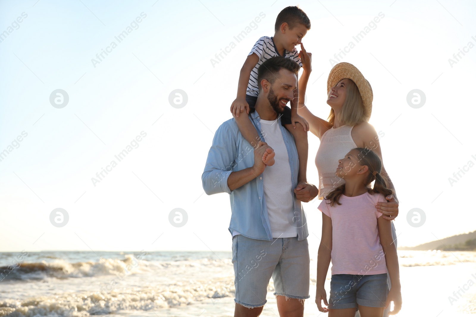 Photo of Happy family on beach near sea. Summer vacation