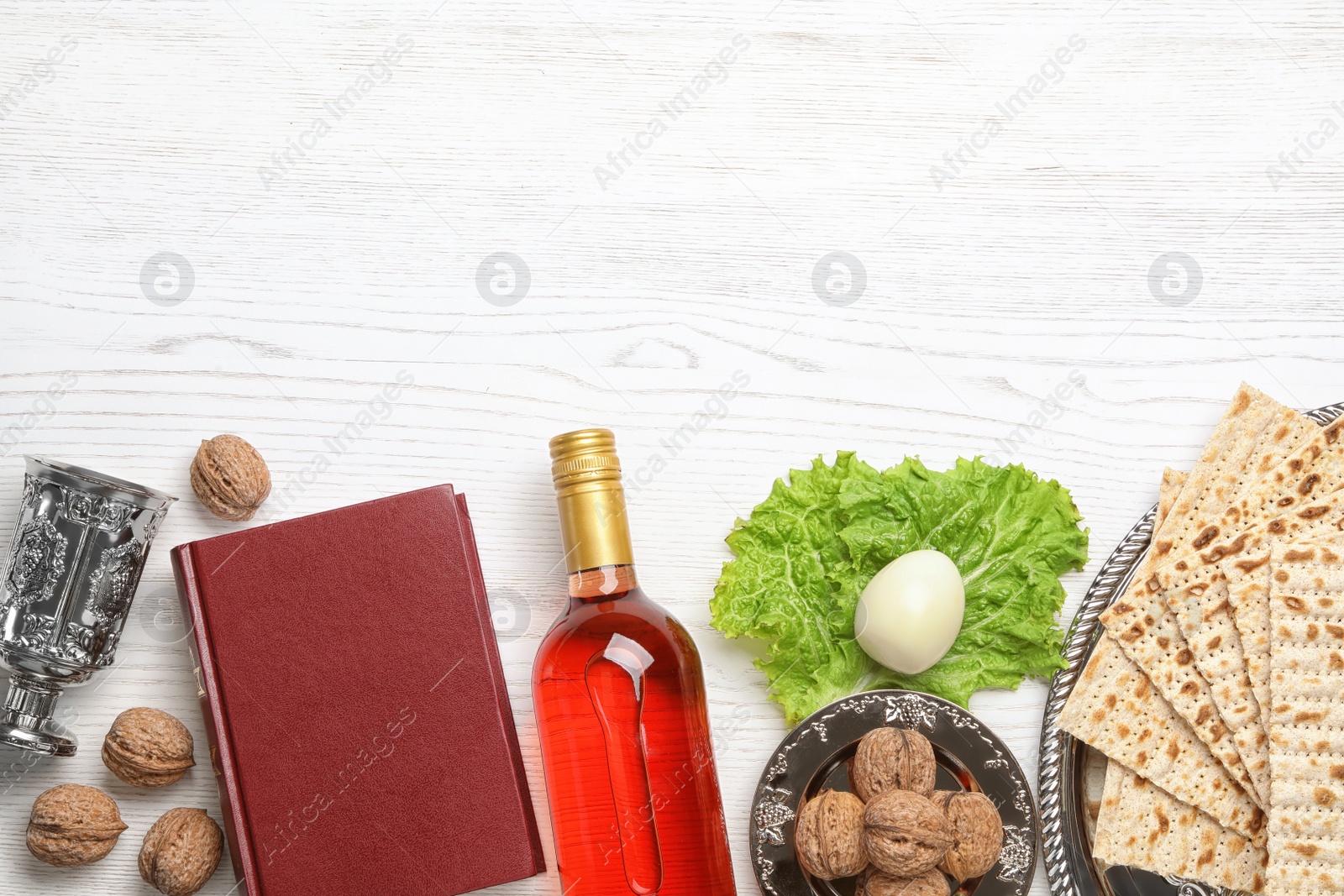 Photo of Flat lay composition with symbolic Passover (Pesach) items on wooden background, space for text