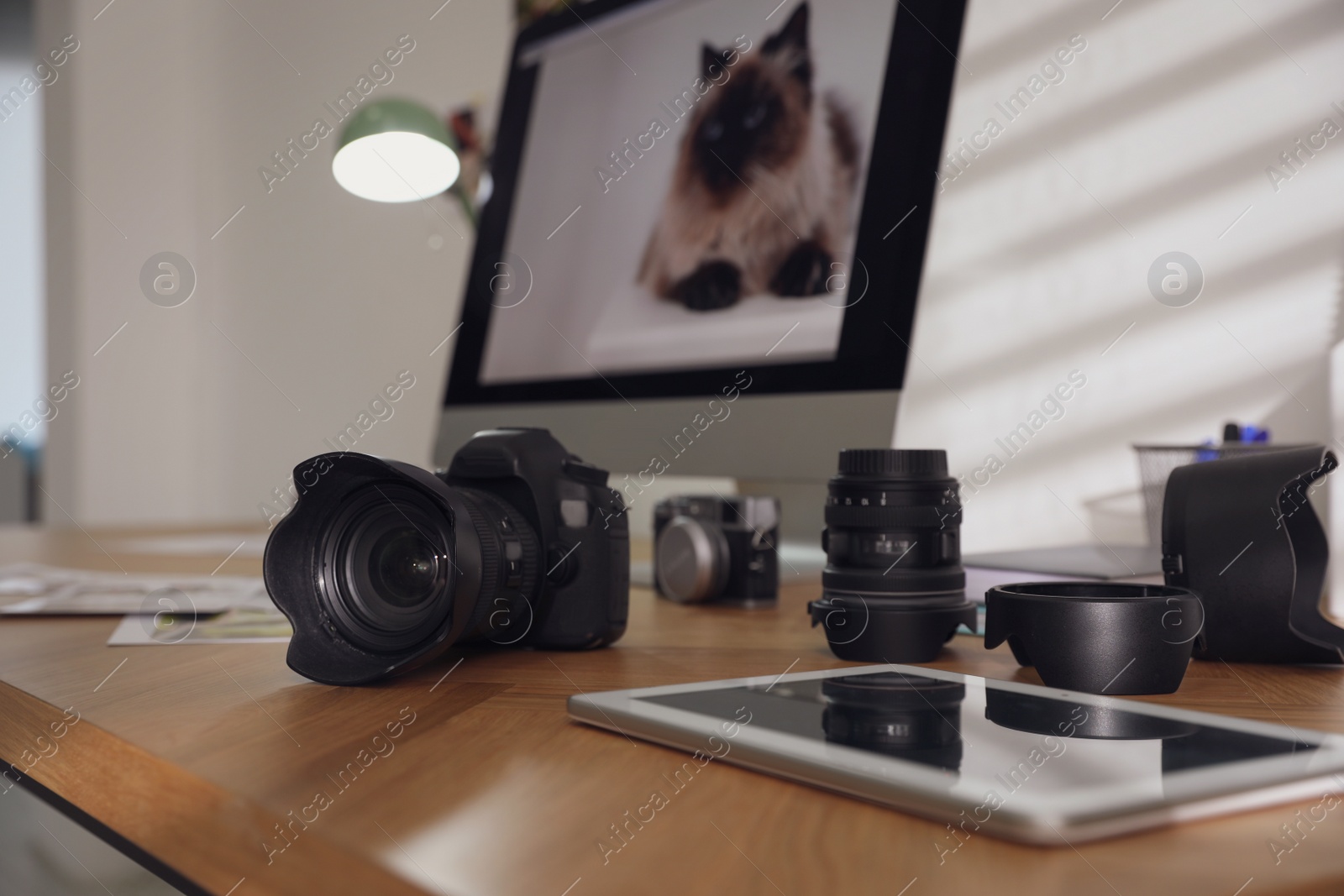 Photo of Photographer's workplace with professional camera in office