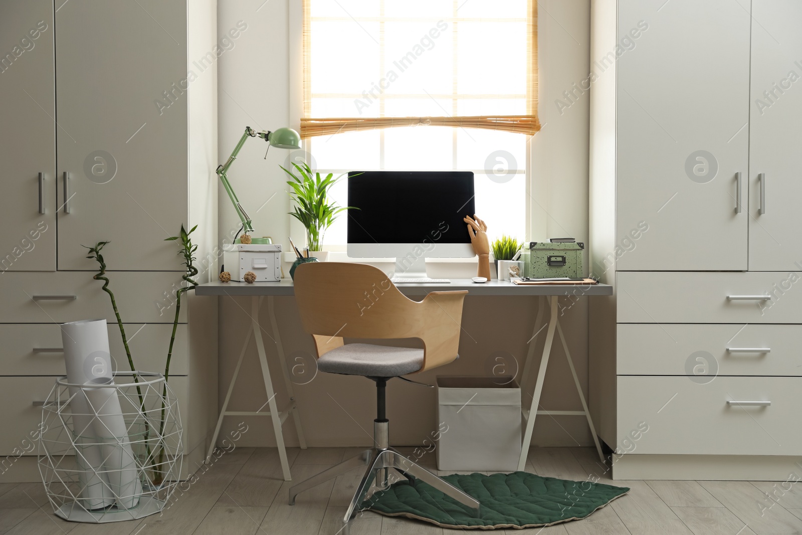 Photo of Light work place with computer near window at home. Interior design