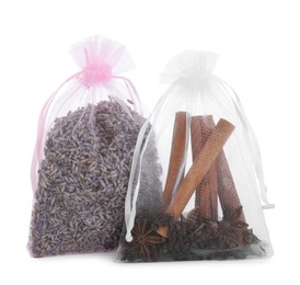 Photo of Scented sachets with cinnamon, anise and dried lavender flowers isolated on white