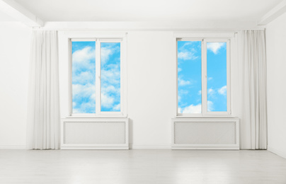 Beautiful view on blue sky with clouds through windows in room