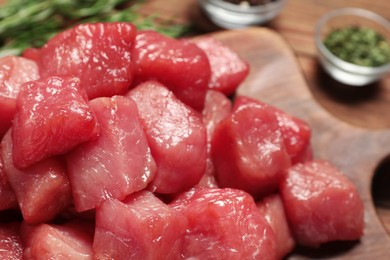 Photo of Cooking delicious goulash. Raw beef meat on wooden board, closeup