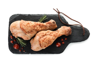 Photo of Board with fried chicken drumsticks on white background, top view. Delicious meat