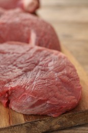 Photo of Pieces of raw beef meat on table, closeup