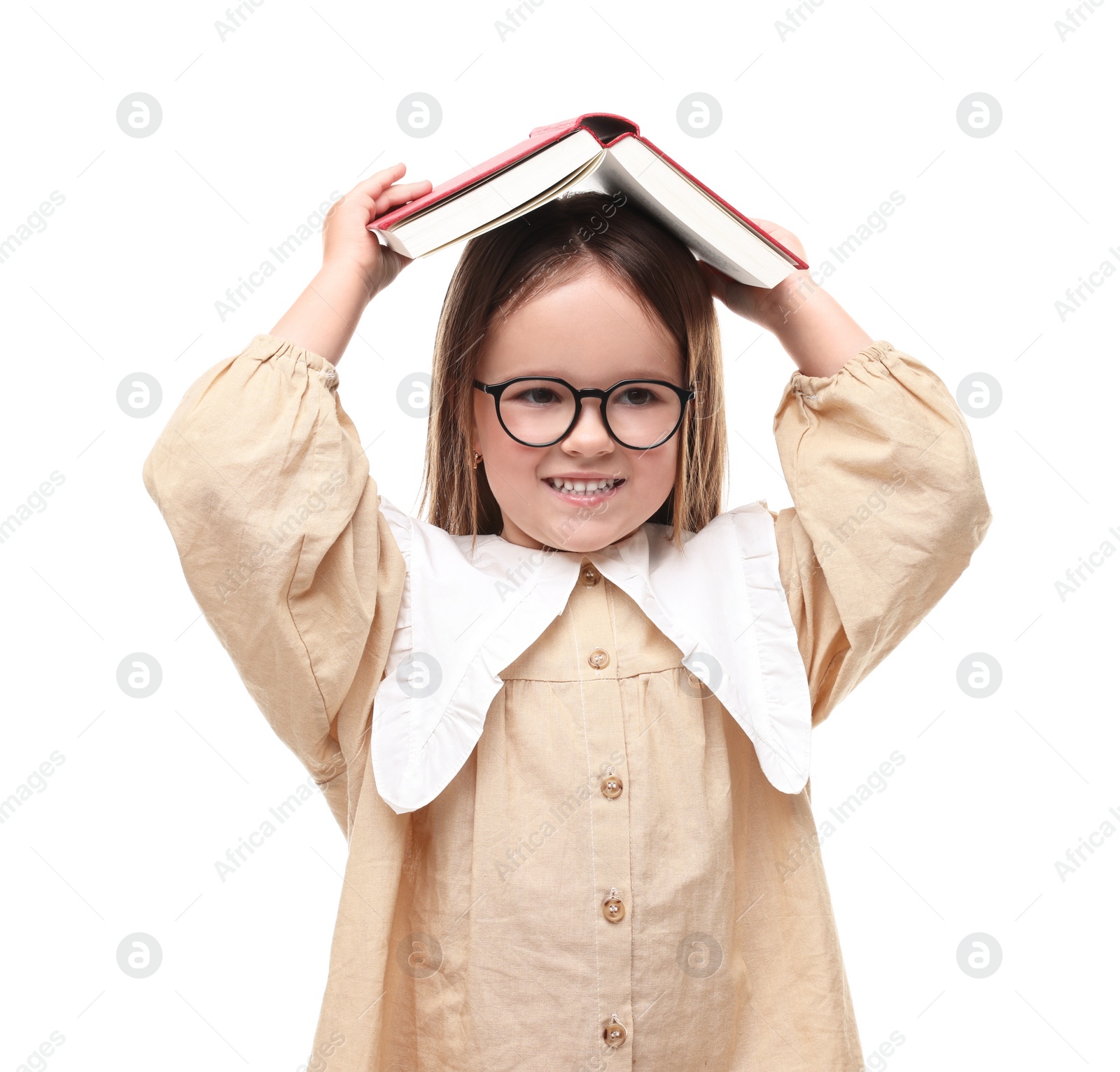 Photo of Cute little girl in glasses with open book on white background