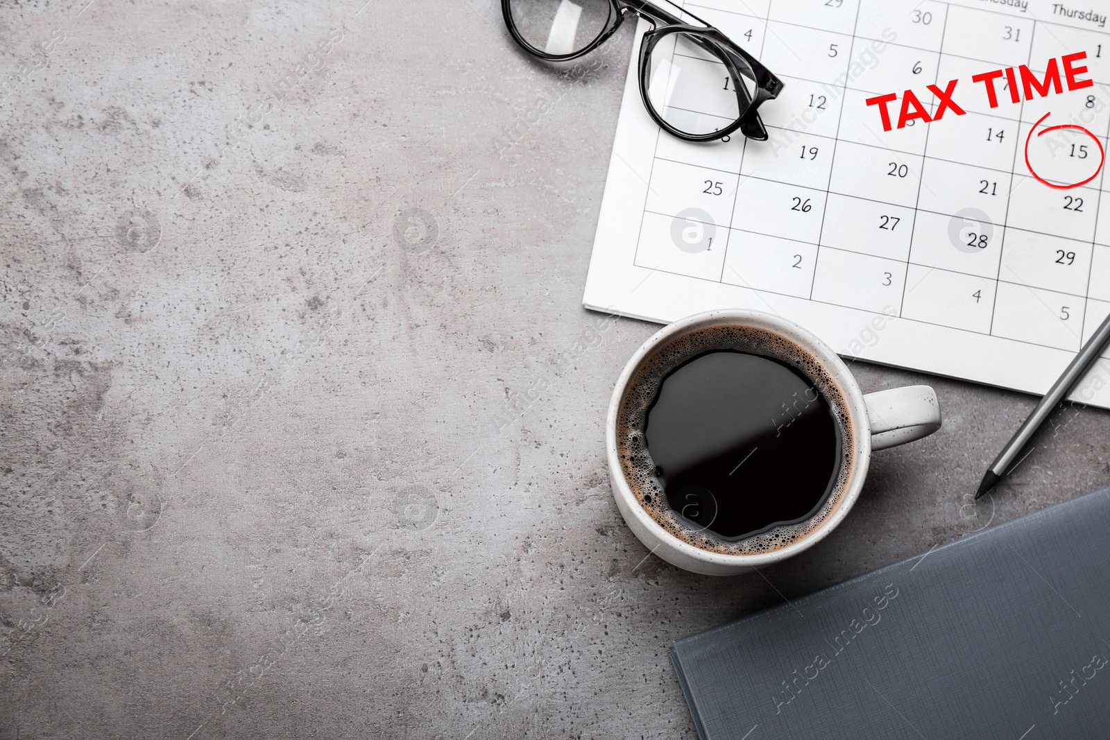 Image of Calendar with words TAX TIME and cup of coffee on grey table, flat lay. Space for text