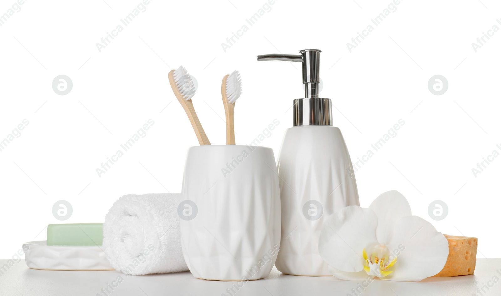 Photo of Bath accessories. Different personal care products and flower on table against white background