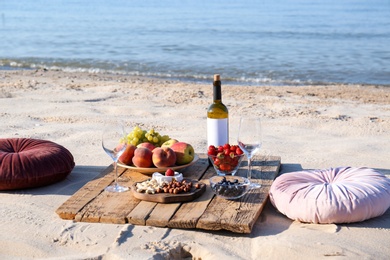Photo of Food and wine on beach. Summer picnic