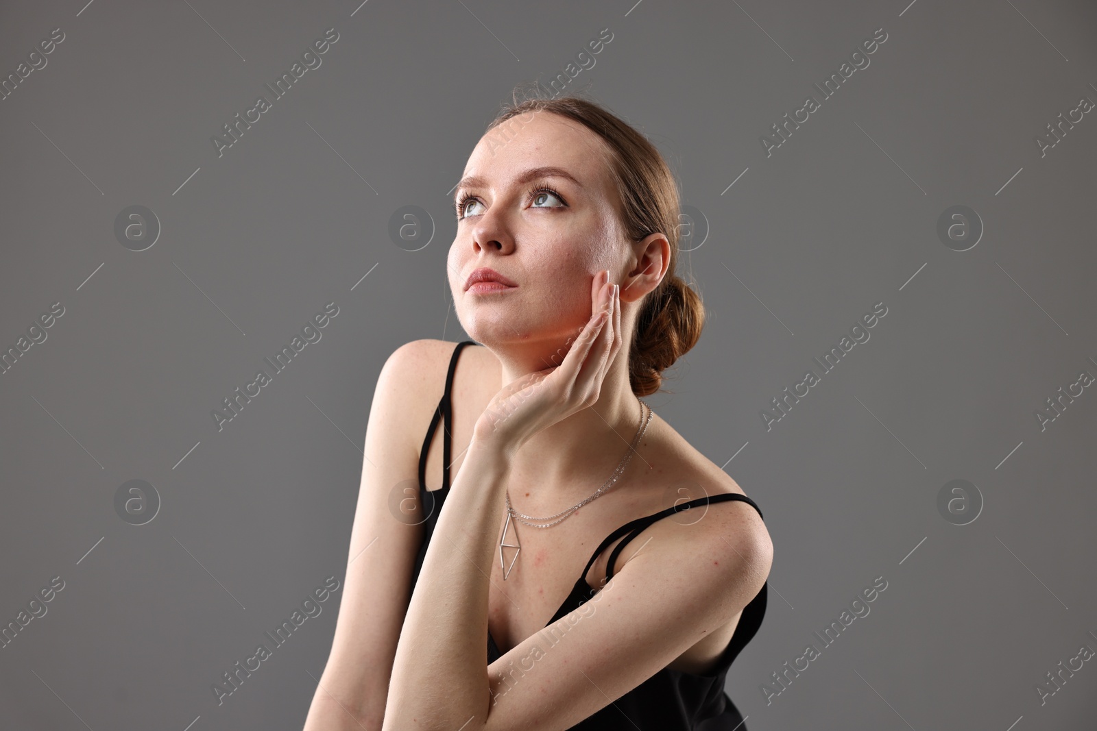 Photo of Fashionable portrait of beautiful young woman on grey background