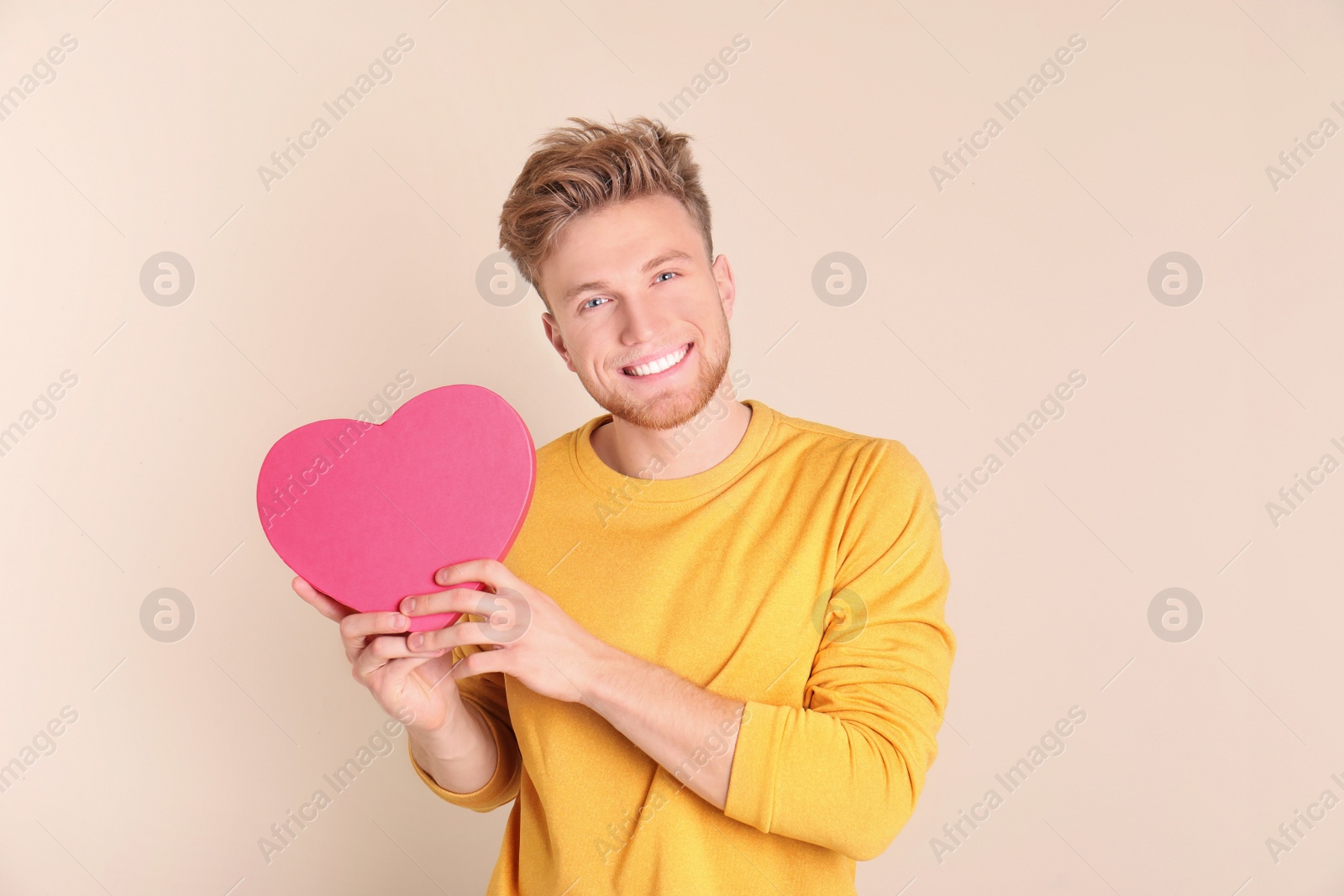 Photo of Portrait of young man with decorative heart on color background