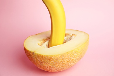Photo of Fresh melon and banana on pink background. Sex concept