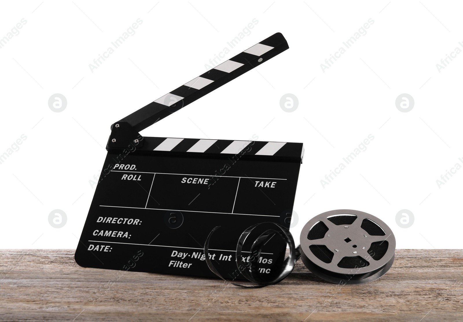 Photo of Movie clapper and film reel on wooden table against white background