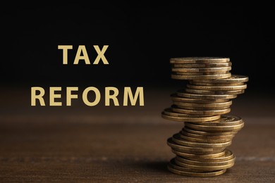 Image of Tax refrom concept. Many coins stacked on wooden table against black background